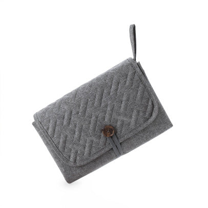 Tapis à langer nomade plié, coloris gris
